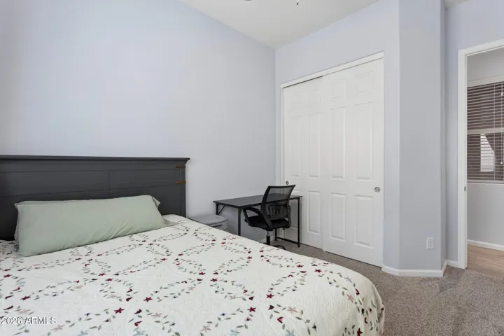 Secondary bedroom with fan and large closet