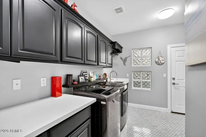 ...with cabinets, sink, extra storage closet and extensive counter space
