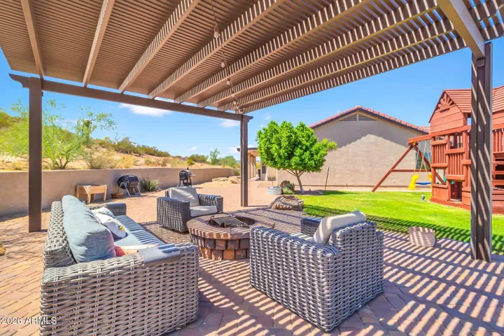 Side yard with pergola and grassy playground area