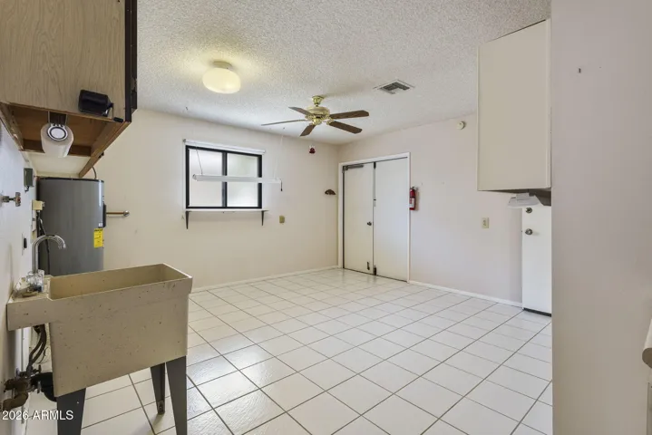 Utility Sink in hobby room. See the double doors to garage for Golf Cart.