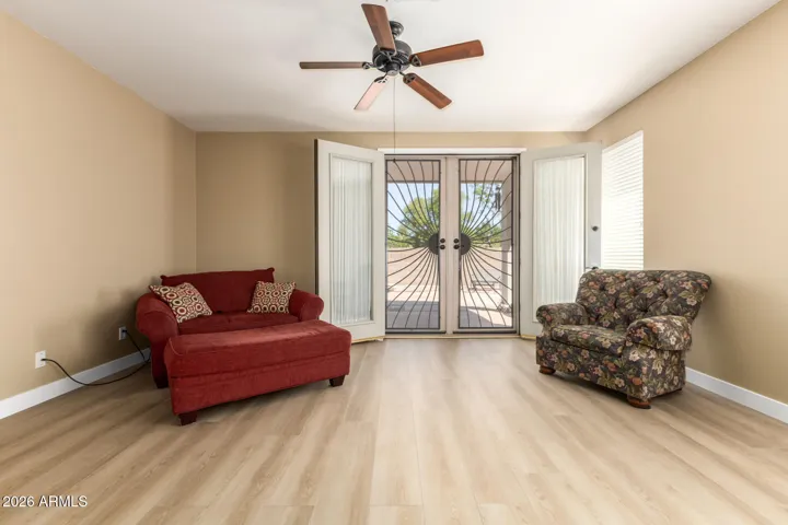 Comfy family room open with double security doors to large backyard.