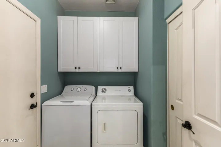Inside laundry with new cabinets and pantry for lots more storage!