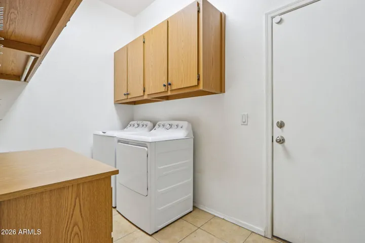 laundry room with cabinets for additional storage