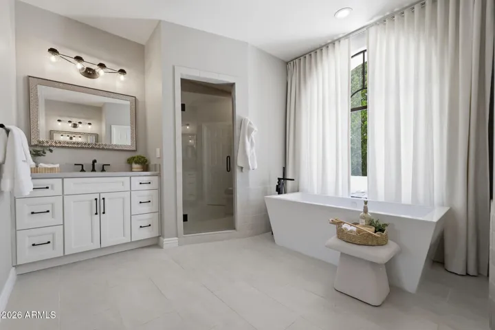 Remodelled primary bath with soaking tub, walk-in shower and dual vanities