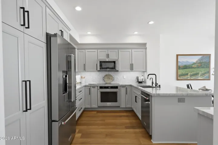 Featuring new KitchenAid appliances, induction cooktop, and Quartzite countertops