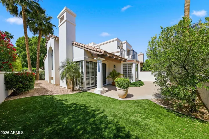 Private backyard with covered patio and multiple seating areas