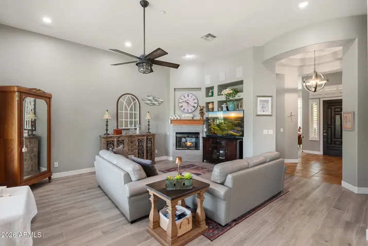 Charming fireplace and spacious room for relaxation or gatherings.