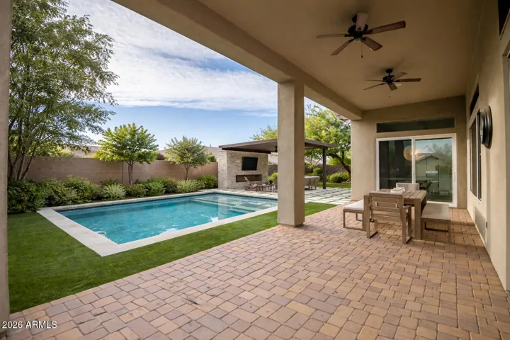 This photo has been virtually staged to add the pool and landscape