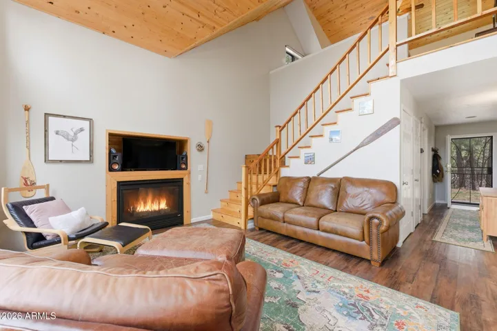 With gas fireplace and stairs to loft area