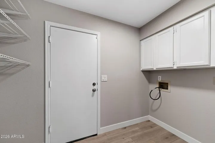 Inside Laundry with cabinets and storage!