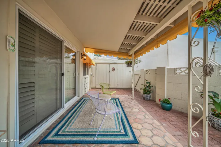 South facing covered back patio with attached shed for extra storage