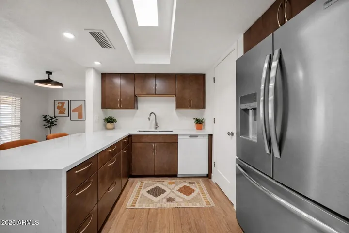 Remodeled kitchen with contemporary cabinets & new SS appliances waterfall counter top