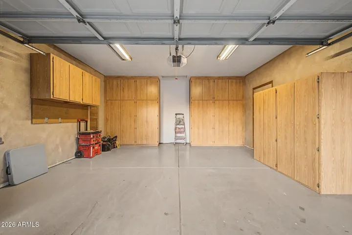 2 car garage with Cabinetry and Epoxy Floor + Storage Room