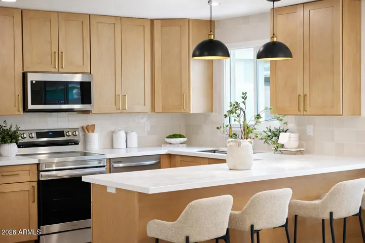 Upgraded kitchen with custom cabinetry, quartz countertops, and designer fixtures
