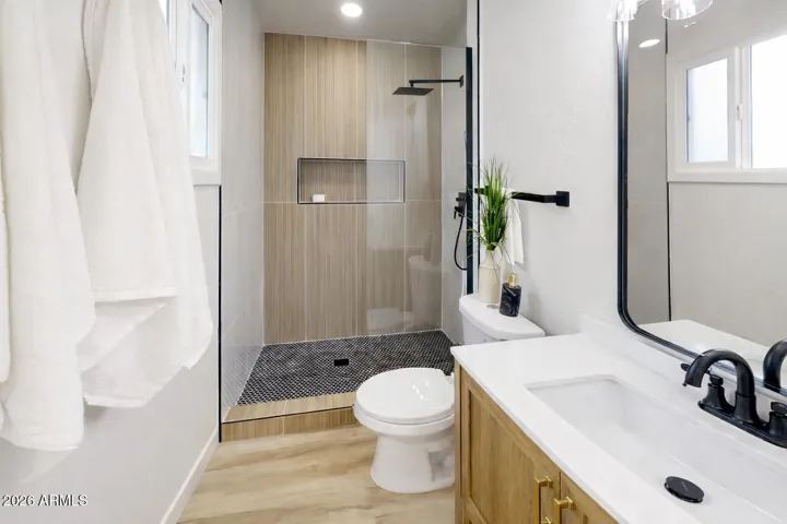 Upgraded bathroom with walk-in shower, custom tile work, and modern finishes