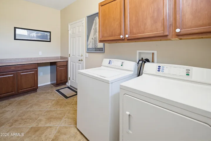 Inside laundry with storage cabinets