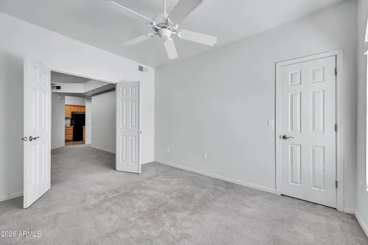 Bedroom #2 looking out into the main living space. Walk in closet