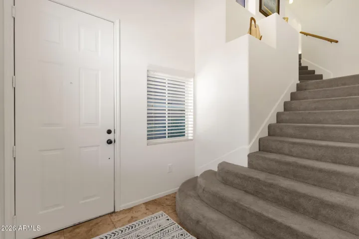 Tile entry with carpeted stairs to main level