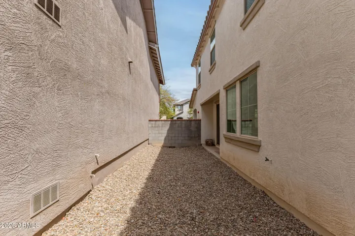 The side yard offers a blank canvas, ready for your vision.