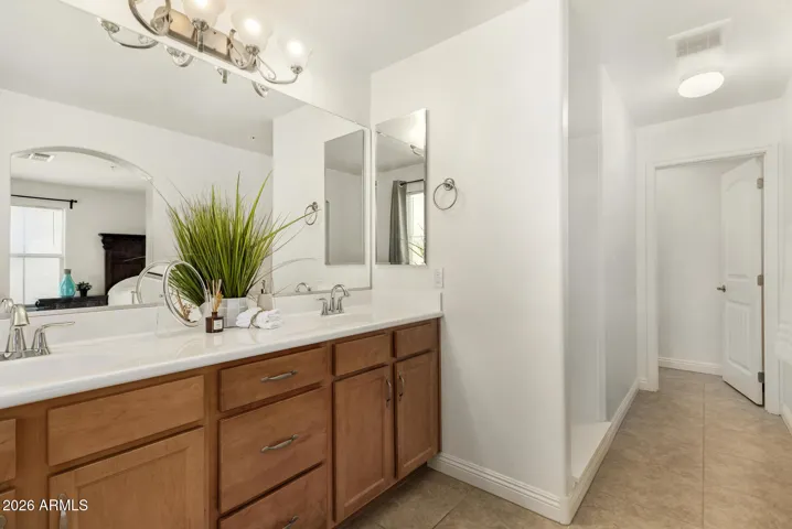 Primary bathroom features double sinks for added convenience and a walk in shower.
