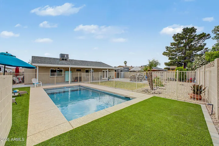 Synthetic turf inside the pool fenced area for easy upkeep