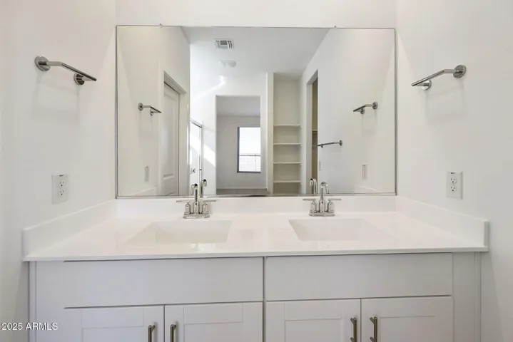 DUAL VANITIES WITH PAINTED CABINETS LARGE SHOWER AND WALK IN CLOSET