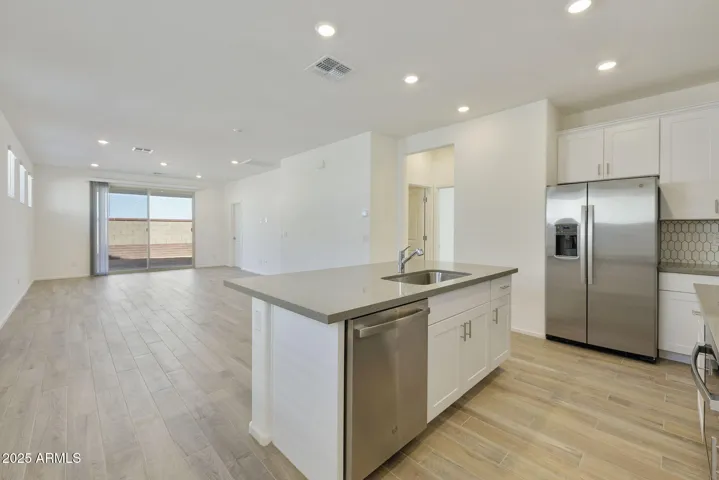 BEAUTIFUL PAINTED CABINETS, UPGRADED QUARTZ COUNTERS, DESIGNER BACKSPLASH, GAS COOKTOP, BUILT-IN OVEN AND REFRIGERATOR INCLUDED!!! PHOTOS ARE OF ANOTHER PLAN WITH SIMILAR OPTIONS