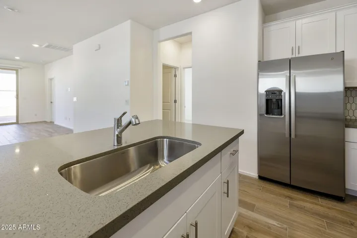 BEAUTIFUL PAINTED CABINETS, UPGRADED QUARTZ COUNTERS, DESIGNER BACKSPLASH, GAS COOKTOP, BUILT-IN OVEN AND REFRIGERATOR INCLUDED!!! PHOTOS ARE OF ANOTHER PLAN WITH SIMILAR OPTIONS
