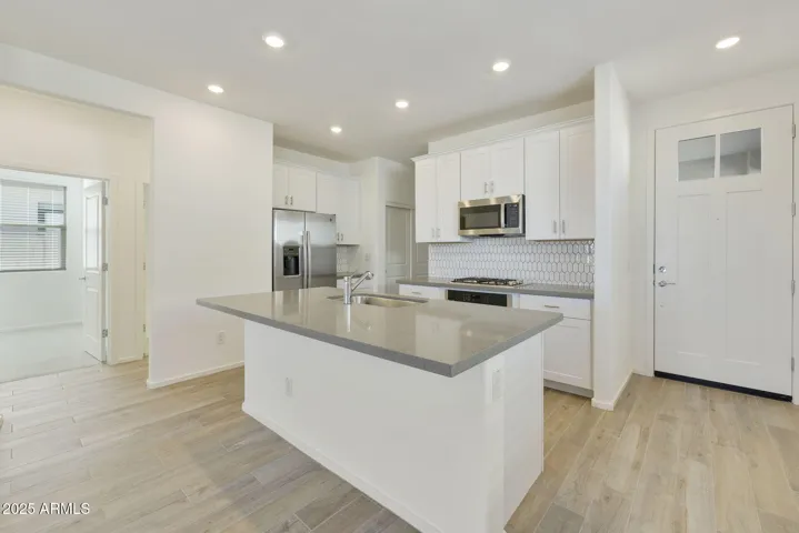 BEAUTIFUL PAINTED CABINETS, UPGRADED QUARTZ COUNTERS, DESIGNER BACKSPLASH, GAS COOKTOP, BUILT-IN OVEN AND REFRIGERATOR INCLUDED!!! PHOTOS ARE OF ANOTHER PLAN WITH SIMILAR OPTIONS
