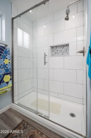 Beautiful tiled shower with glass surround.