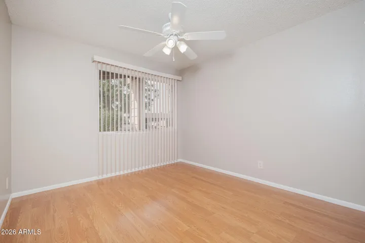 Laminate wood floors + ceiling fan.