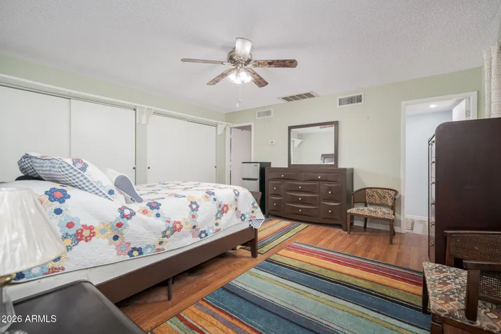 2nd primary bedroom is massive & features laminate wood flooring, ceiling fan, LOTS of closet space + updated full bathroom.