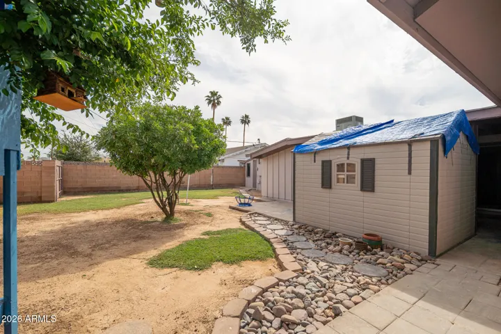 Large back yard with block fence. (storage shed will not convey)