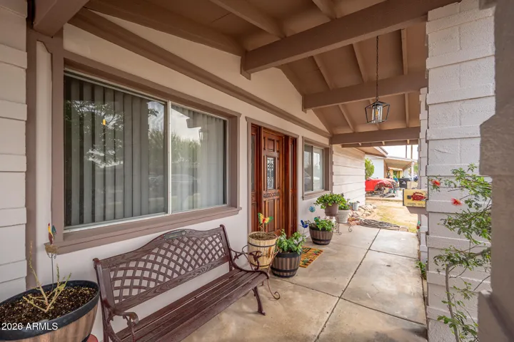 Cozy front porch is a perfect place to have your morning coffee.