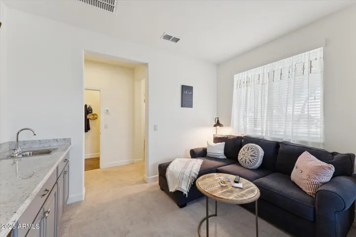 Guest en-suite wet bar leading into designated workspace and bathroom