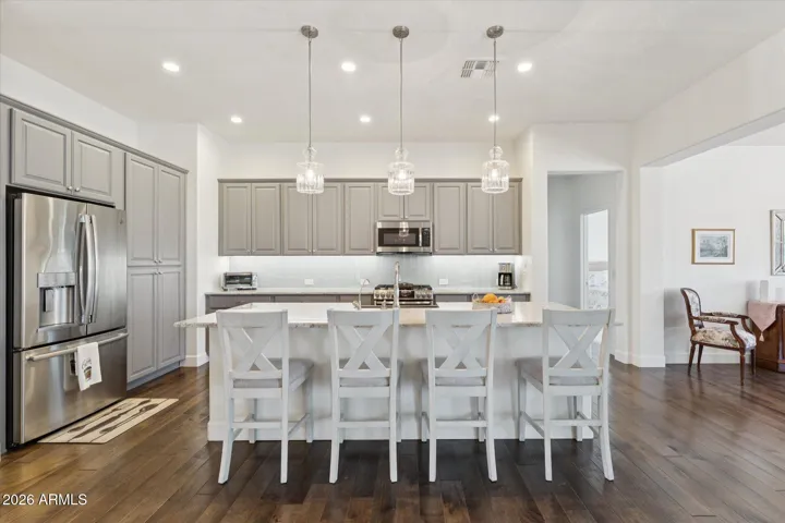 Highly upgraded kitchen with quartz counters and glass subway tile full-height backsplash