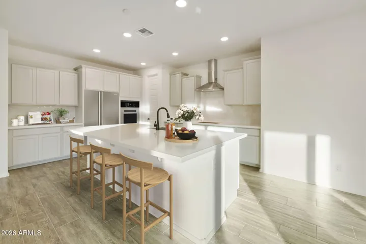 BEAUTIFUL GOURMET KITCHEN WITH BUILT-IN APPLIANCES, PAINTED CABINETS, QUARTZ COUNTERS AND DESIGNER BACKSPLASH.