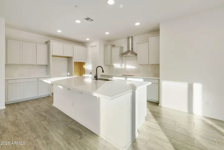 BEAUTIFUL GOURMET KITCHEN WITH BUILT-IN APPLIANCES, PAINTED CABINETS, QUARTZ COUNTERS AND DESIGNER BACKSPLASH.