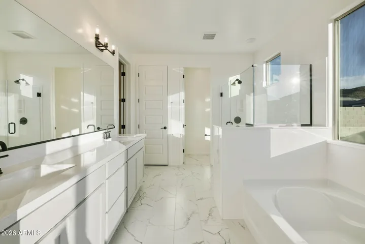 DUAL VANITIES, SEPARATE TUB AND SHOWER, LINEN CLOSET AND LARGE WALK IN CLOSET