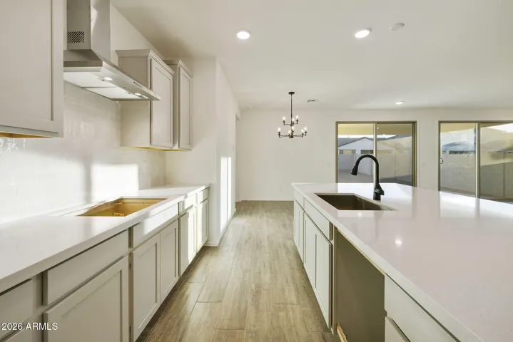 BEAUTIFUL GOURMET KITCHEN WITH BUILT-IN APPLIANCES, PAINTED CABINETS, QUARTZ COUNTERS AND DESIGNER BACKSPLASH.
