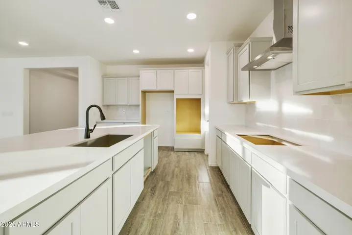 BEAUTIFUL GOURMET KITCHEN WITH BUILT-IN APPLIANCES, PAINTED CABINETS, QUARTZ COUNTERS AND DESIGNER BACKSPLASH.