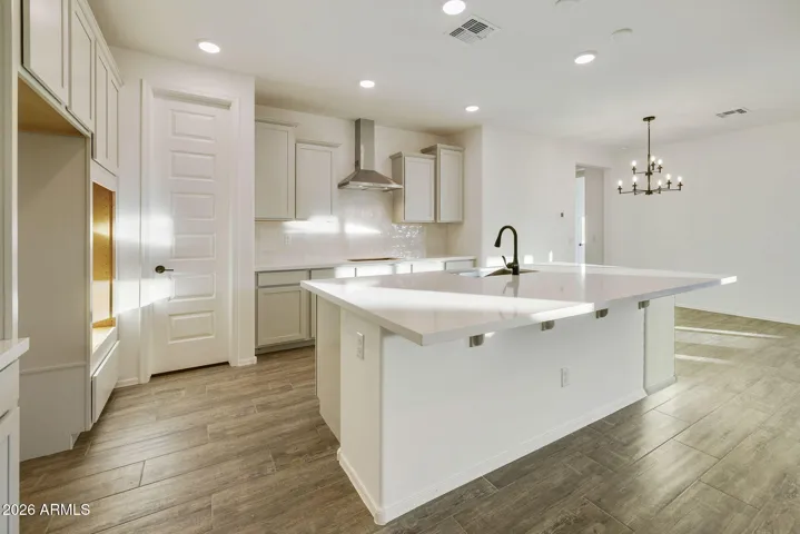 BEAUTIFUL GOURMET KITCHEN WITH BUILT-IN APPLIANCES, PAINTED CABINETS, QUARTZ COUNTERS AND DESIGNER BACKSPLASH.