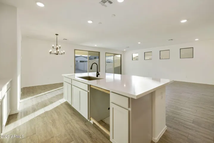 BEAUTIFUL GOURMET KITCHEN WITH BUILT-IN APPLIANCES, PAINTED CABINETS, QUARTZ COUNTERS AND DESIGNER BACKSPLASH.