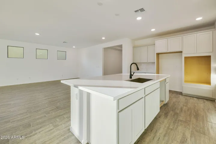 BEAUTIFUL GOURMET KITCHEN WITH BUILT-IN APPLIANCES, PAINTED CABINETS, QUARTZ COUNTERS AND DESIGNER BACKSPLASH.