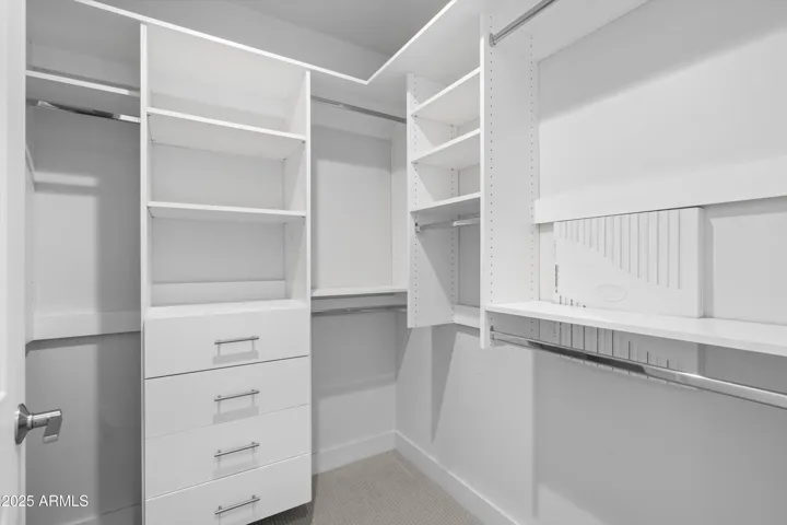 Primary Walk-In Closet. Custom Shelving/Drawers