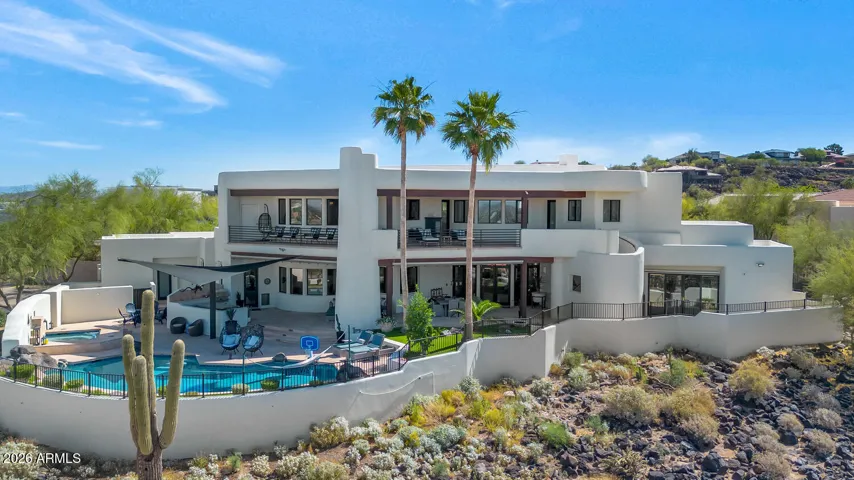 Perched on a scenic desert hillside this home offers a perfect blend of luxury, privacy, and breathtaking views. The home showcases clean architectural lines, expansive balconies, and large windows that invite in natural light and sweeping mountain vistas.