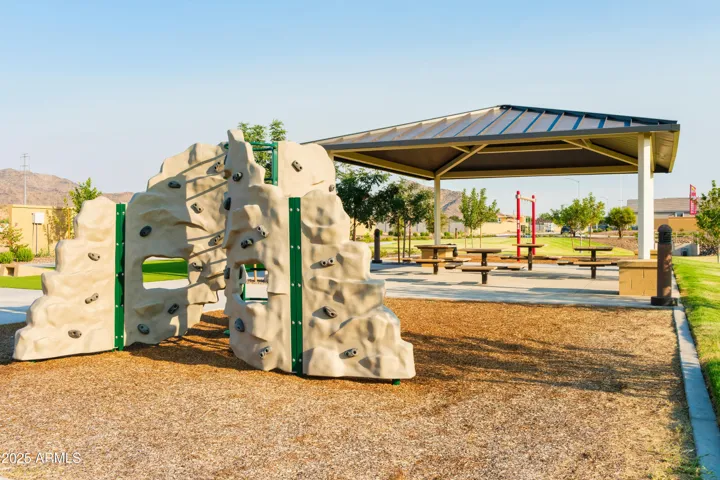 PLAY PARK WITH ROCK CLIMBING, SWINGS, CORN HOLE AND PICNIC AREAS.