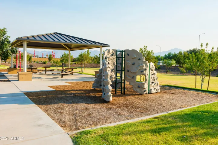 PLAY PARK WITH ROCK CLIMBING, SWINGS, CORN HOLE AND PICNIC AREAS.