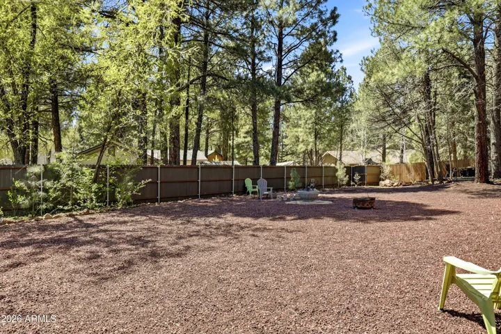Large, private backyard with mature trees and plenty of space to enjoy the outdoors.