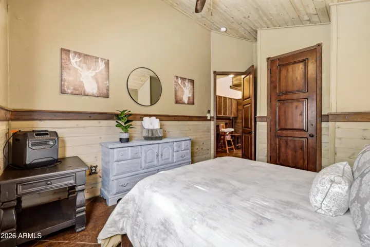 Comfortable bedroom with natural light and warm wood accents.